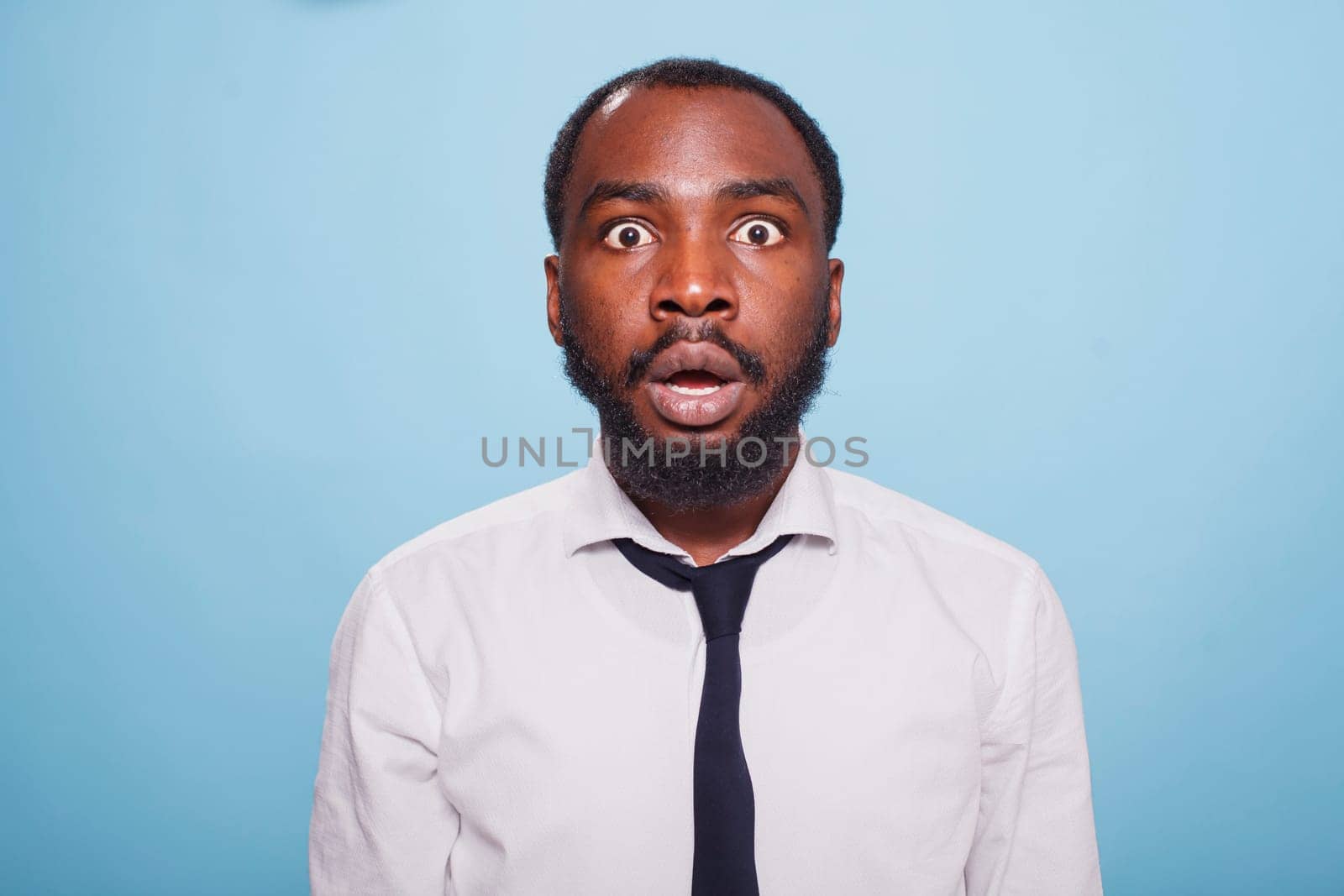 Stunned businessman facing camera by DCStudio