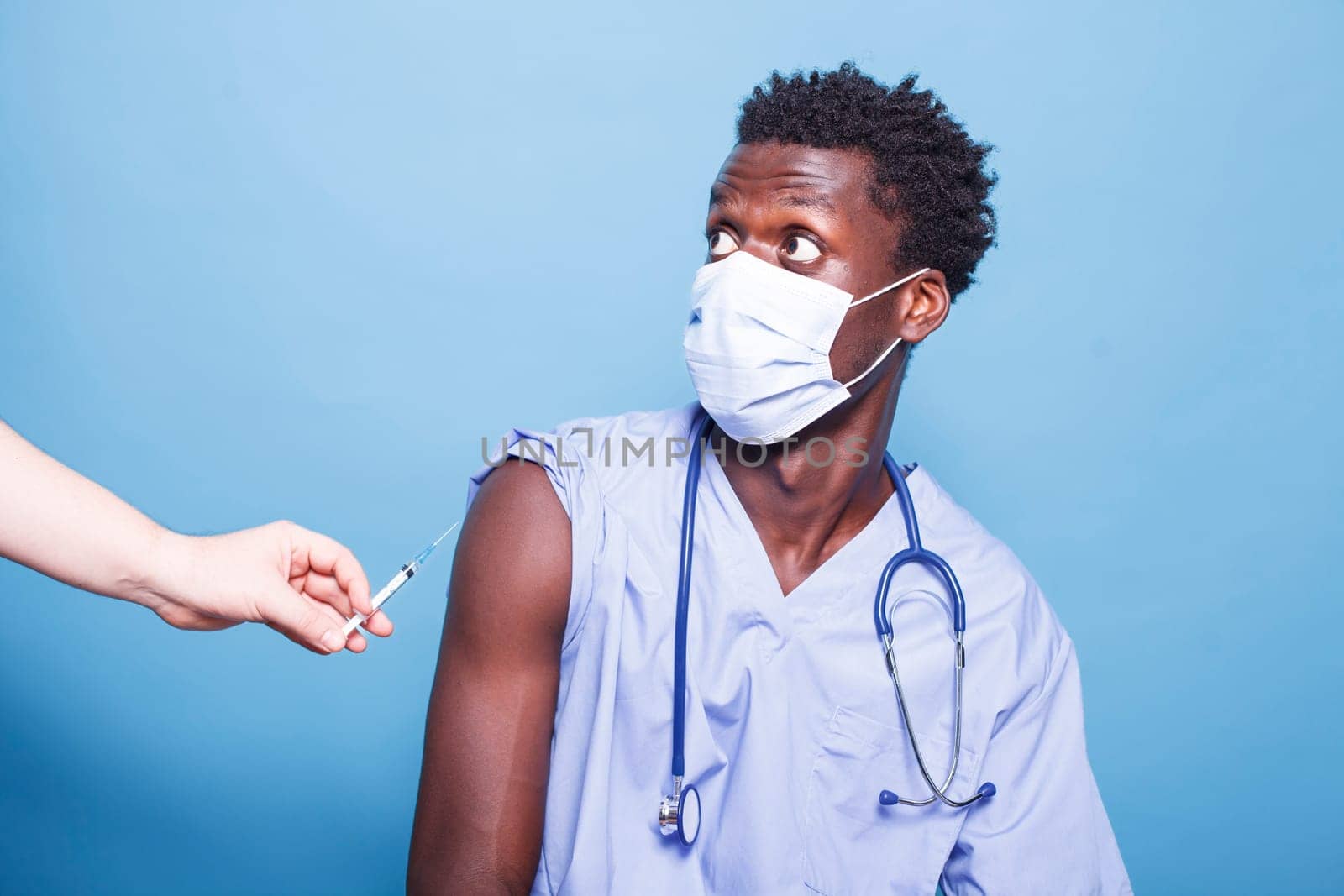 Medical nurse getting vaccinated by DCStudio