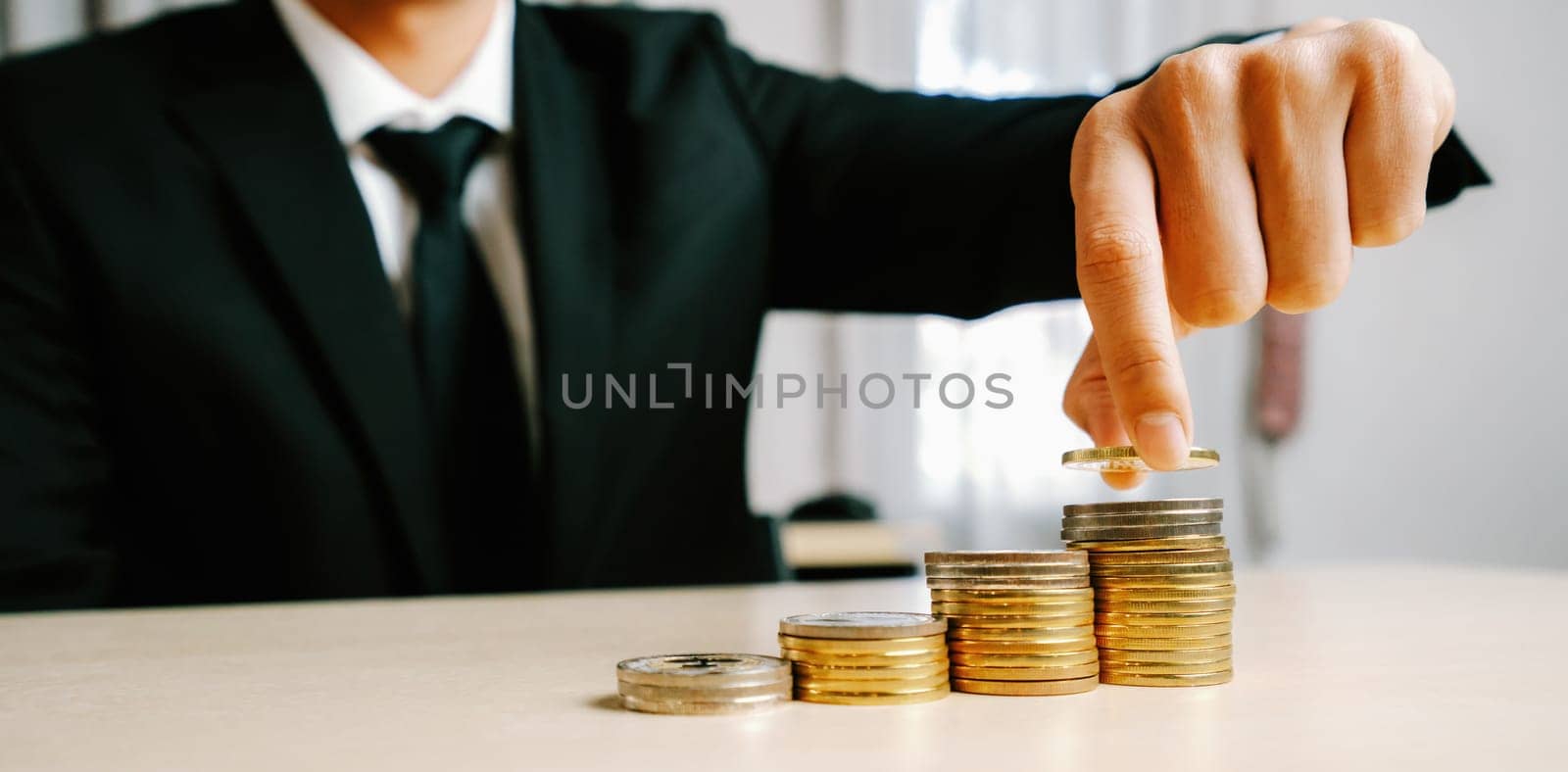 Businessman working with coin money currency. Concept of investment growth and money saving. uds