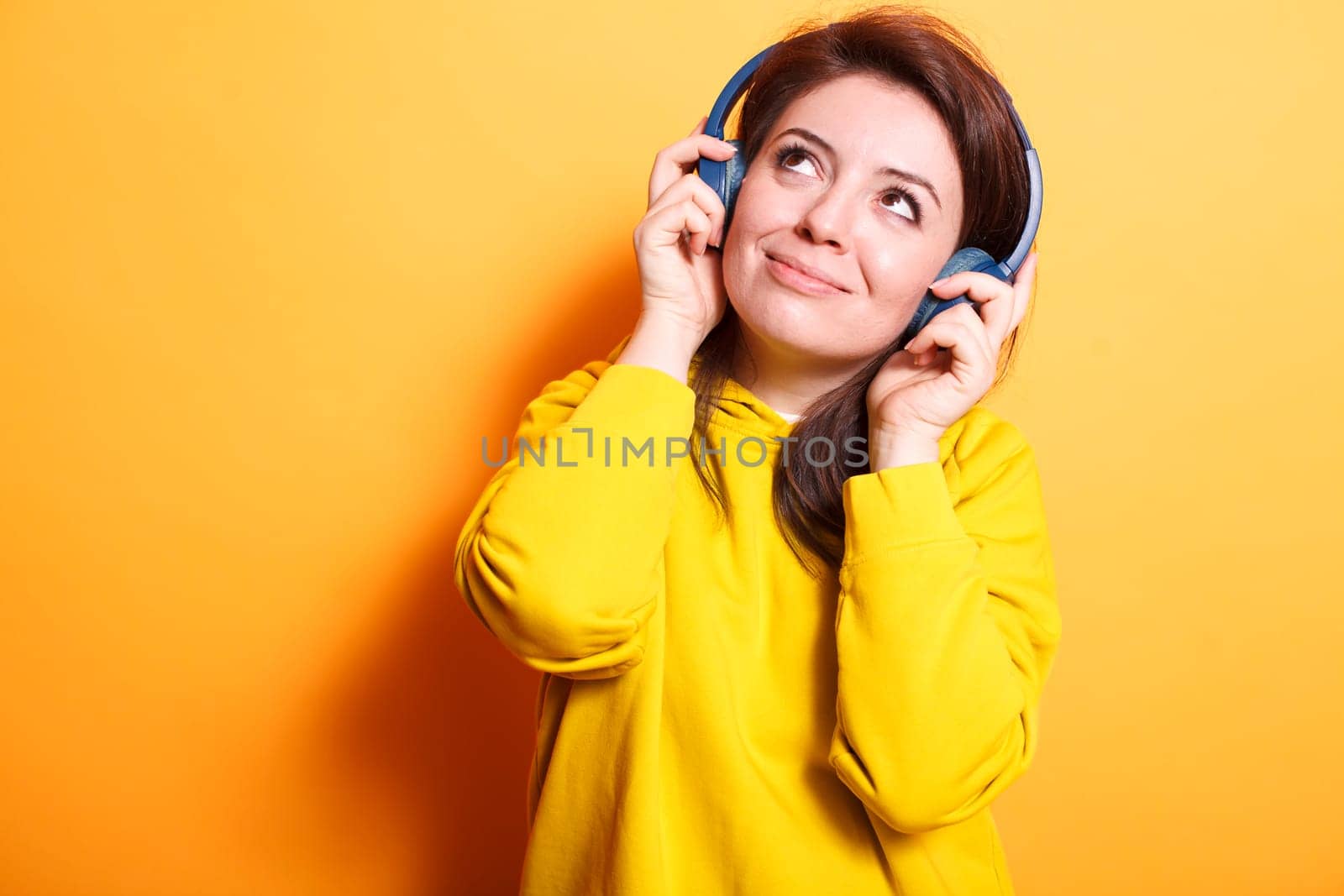 Smiling woman enjoying relaxing songs by DCStudio