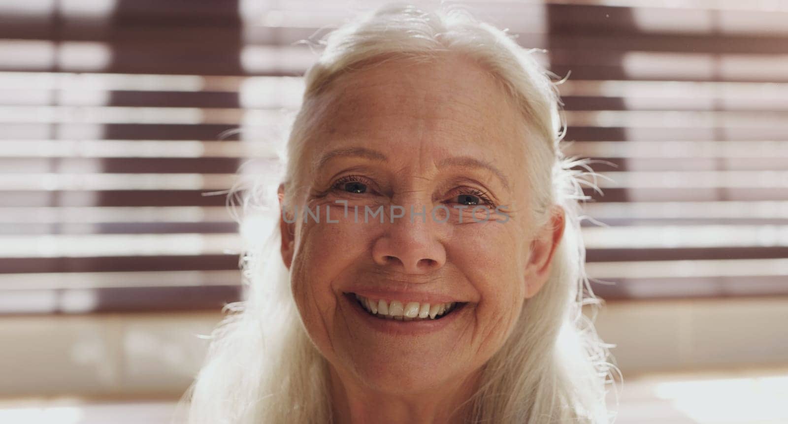 Senior woman, portrait and closeup in house by kitchen for retirement, memories and happiness. Elderly person, face and relax in nursing home on pension for mothers day, peace and calm with smile.
