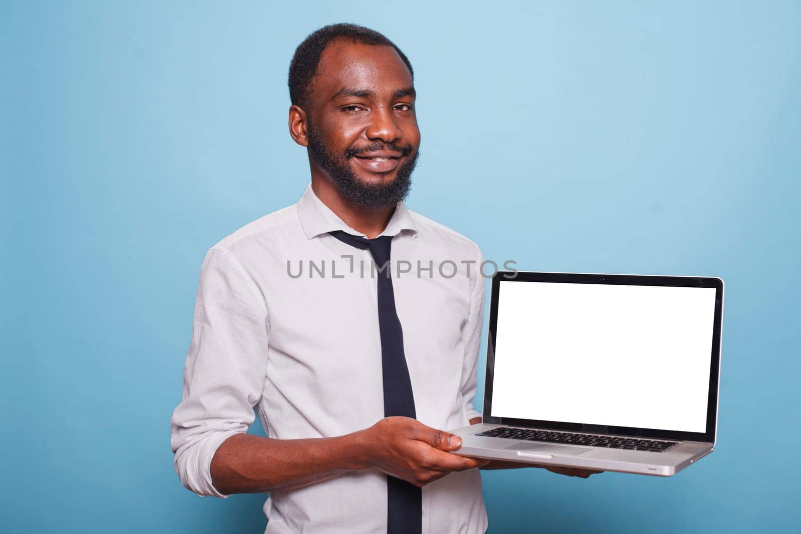 Black man holds laptop with white screen by DCStudio