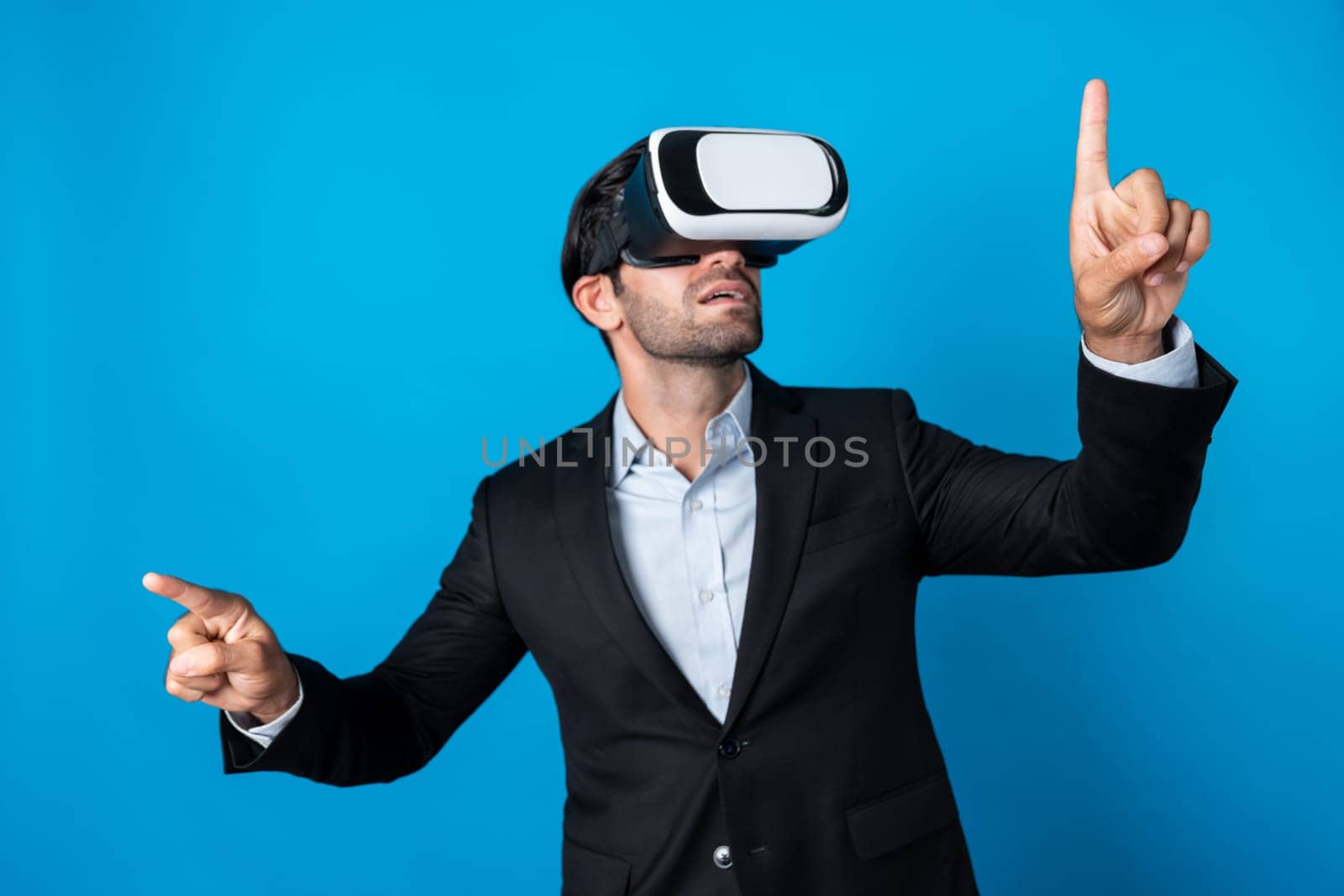 Skilled business man looking at data analysis while wearing VR glasses and suit. Project manager checking and choosing while using visual reality goggles or headset. Innovation technology. Deviation.