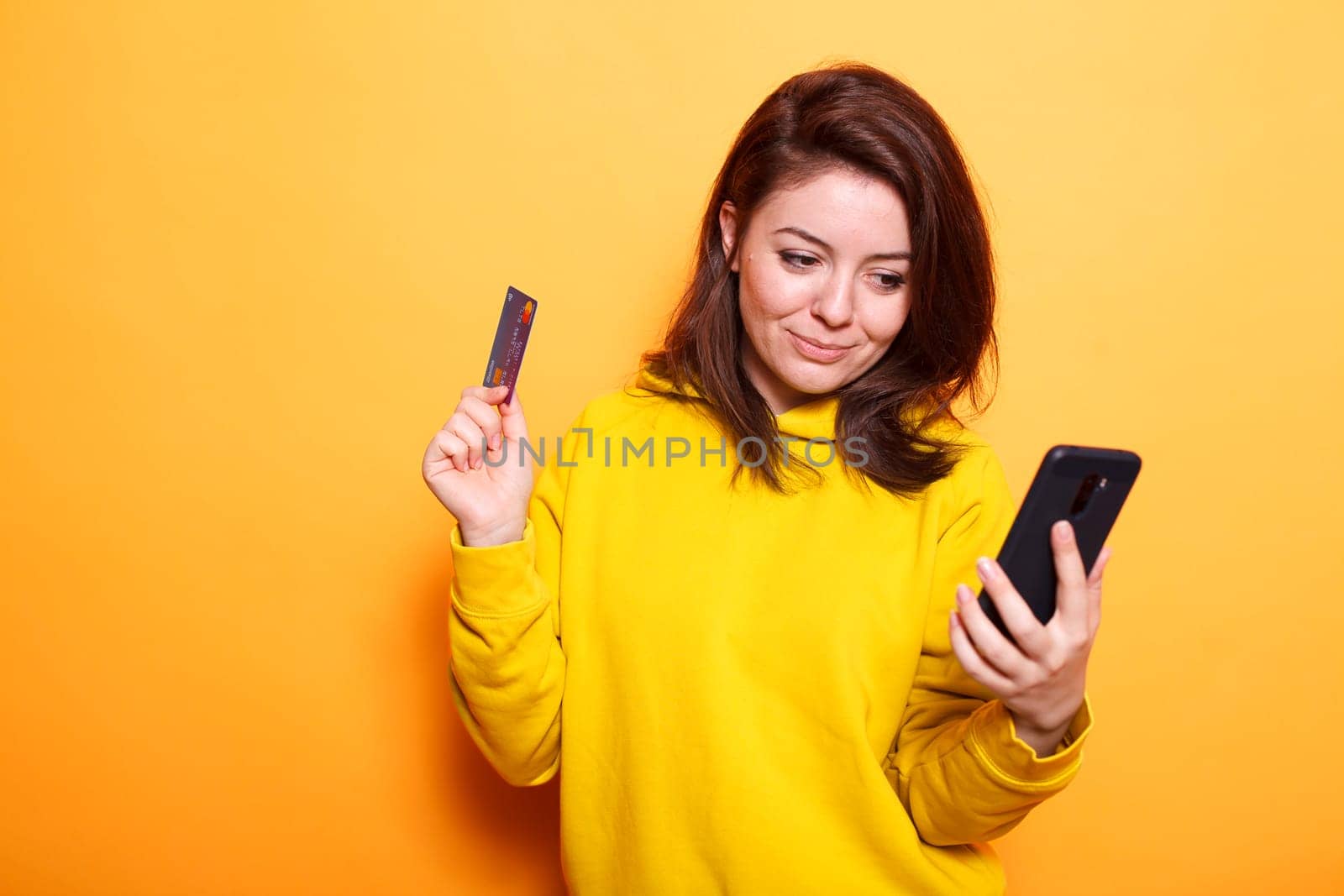 Lady making online payment with card by DCStudio