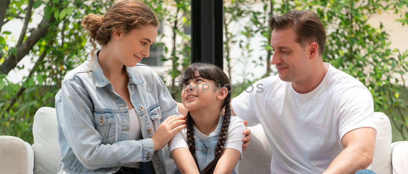 Parents comforting their daughter with loving hug, helping her feel secure and protected from fear, rest her head on shoulder. Happy family love and child care support concept. Panorama Synchronos