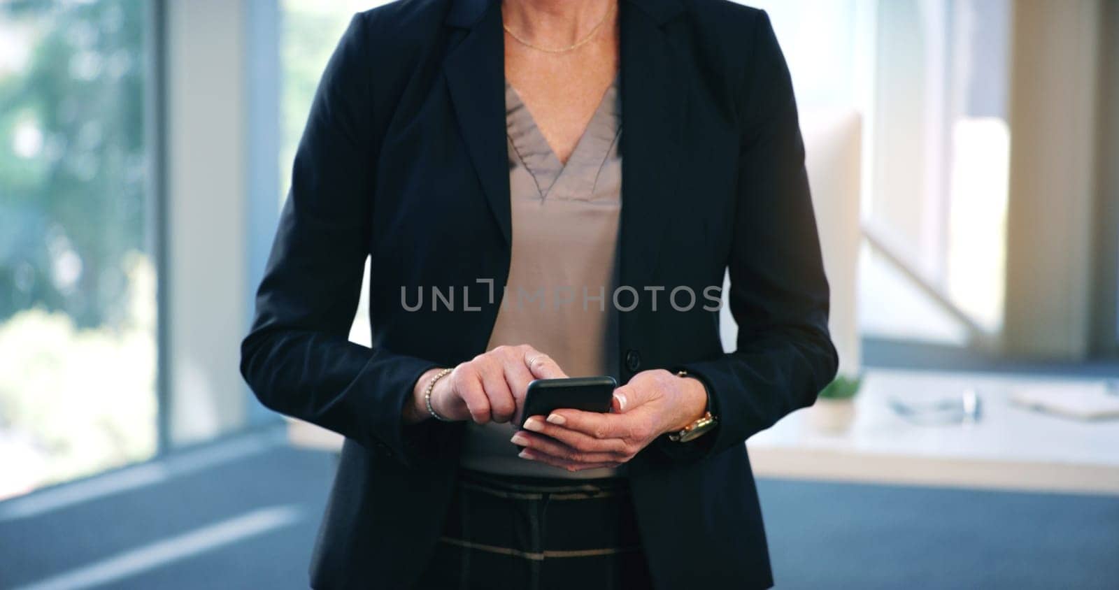 Businesswoman, hands and smartphone in office for typing, browsing and texting online with contact. Technology, connectivity and woman with cellphone for networking, social media or sales person.