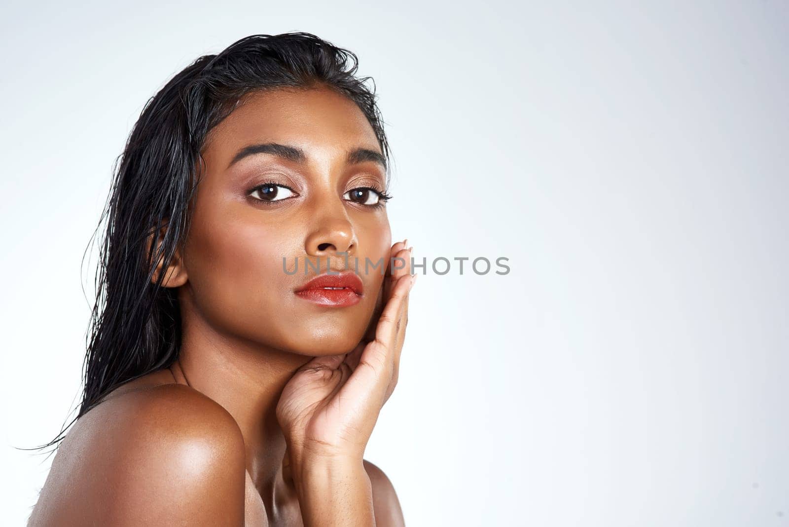 Beauty, studio and portrait of Indian woman with makeup and skincare in mockup space. Model, face and girl with confidence from healthy self care and pride from cosmetics in white background.