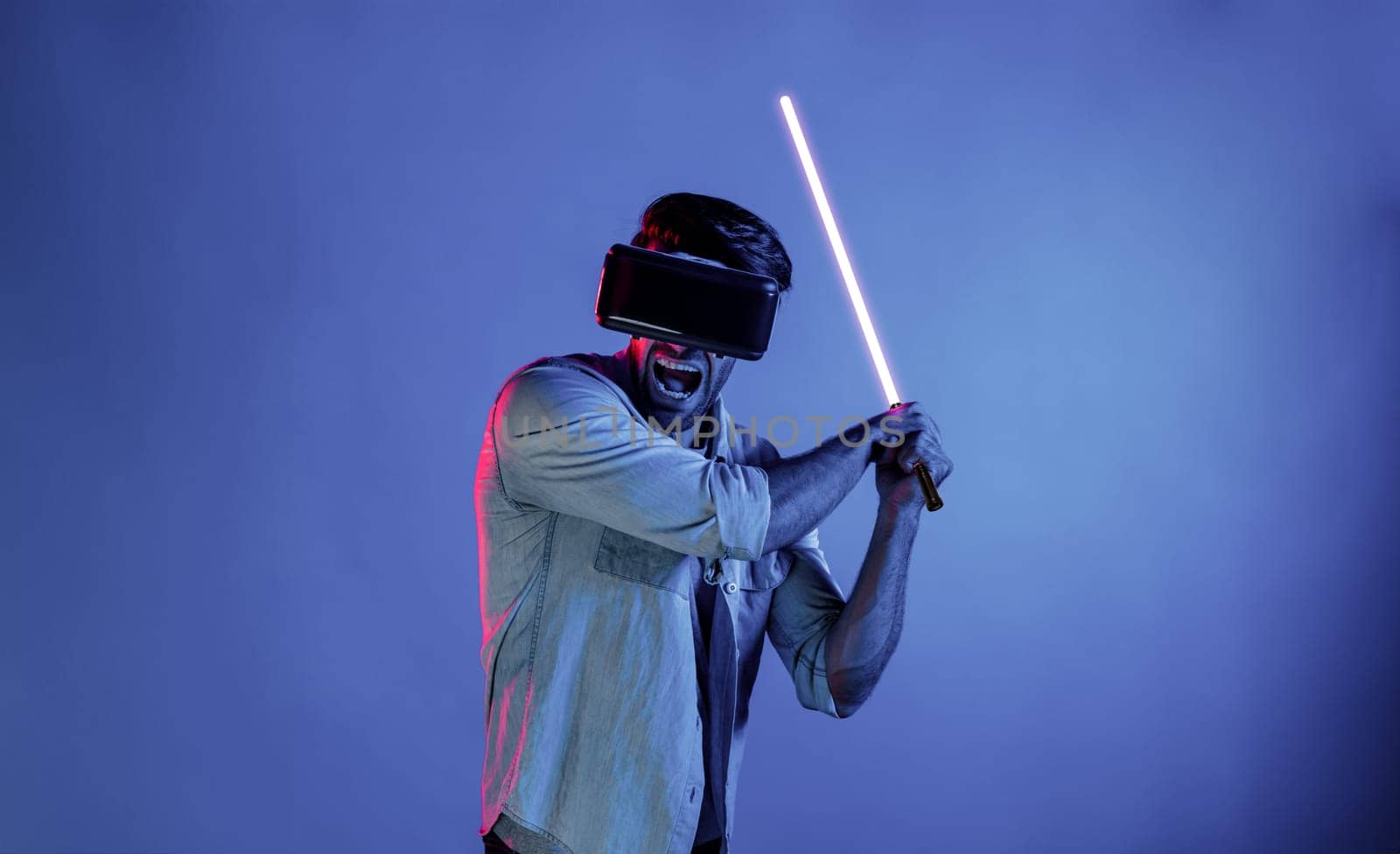 Caucasian man wearing VR glass and moving gesture holding sword. Deviation. by biancoblue