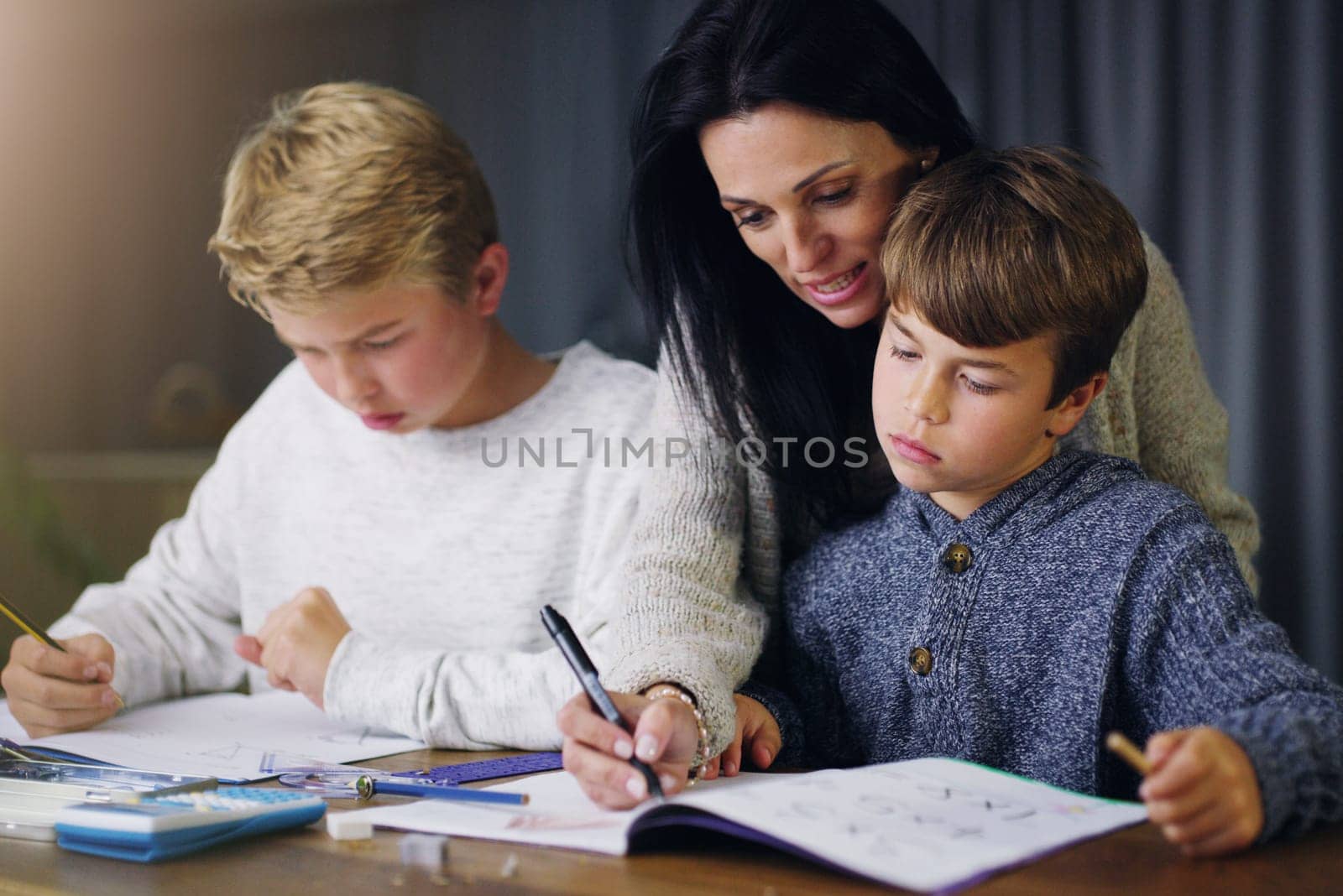 Mother, children and helping with school homework in house or learning education, teaching or lesson. Woman, sons and table in apartment for student knowledge or academic studying, writing or project.