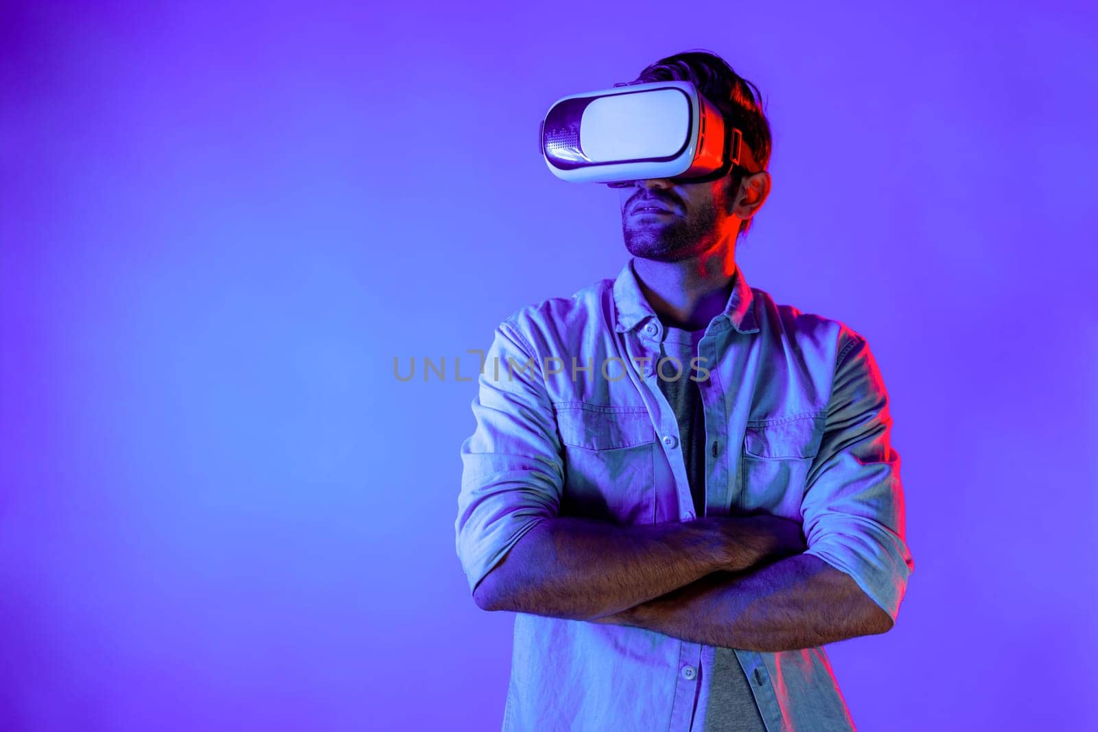 Smart caucasian man using virtual reality glass while crossing arm. Deviation. by biancoblue