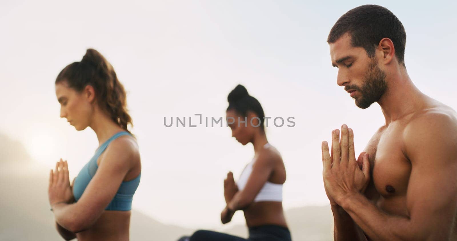 Man, women and meditation for spiritual zen or outdoor morning mist, mindfulness or healing. Friends, hands and wellness chakra for self care or inner peace at beach for yogi calm, holistic or nature.