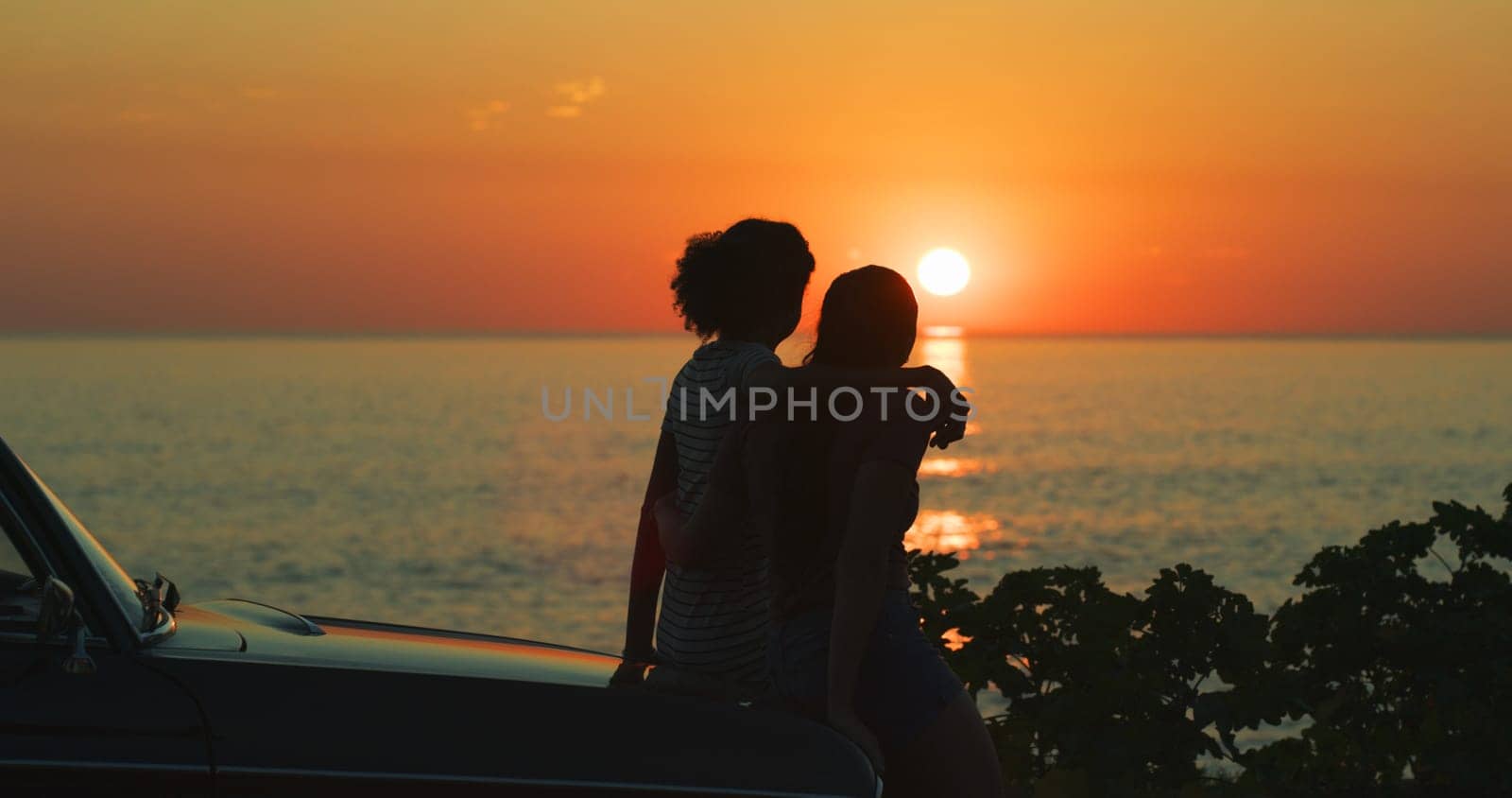 Sunset, hug and beach with couple, car and travel with adventure, vacation and getaway trip. Silhouette, people and ocean with summer, outdoor or nature with view and romance with vehicle and holiday by YuriArcurs