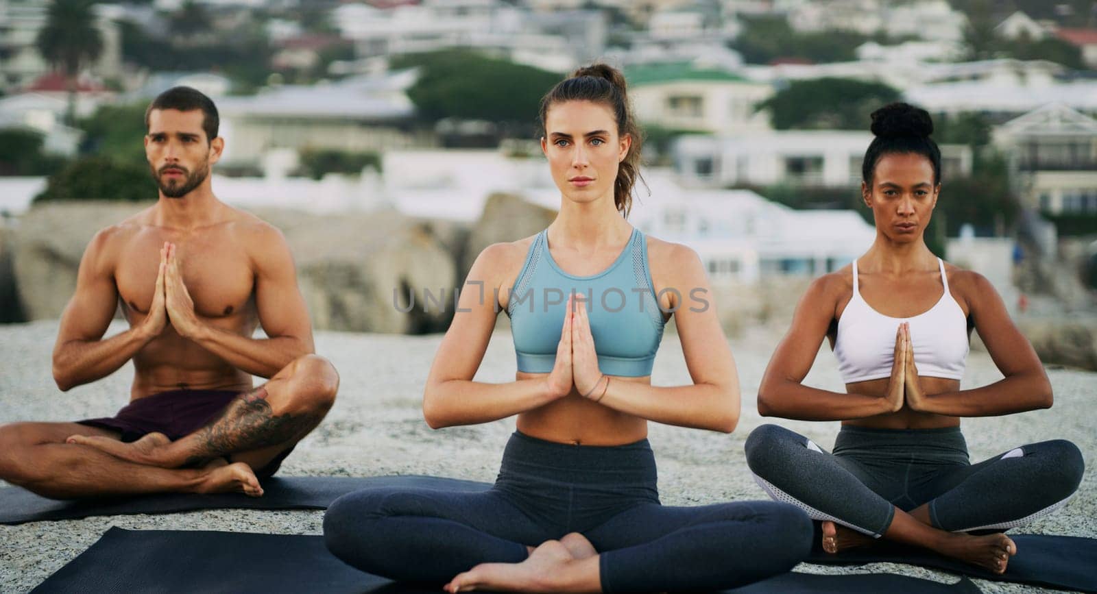 Meditation, group and together outside for yoga, wellness and chakra in sitting and praying hands position for peace. Mindfulness, exercise and zen for spiritual balance, awareness and people relax.