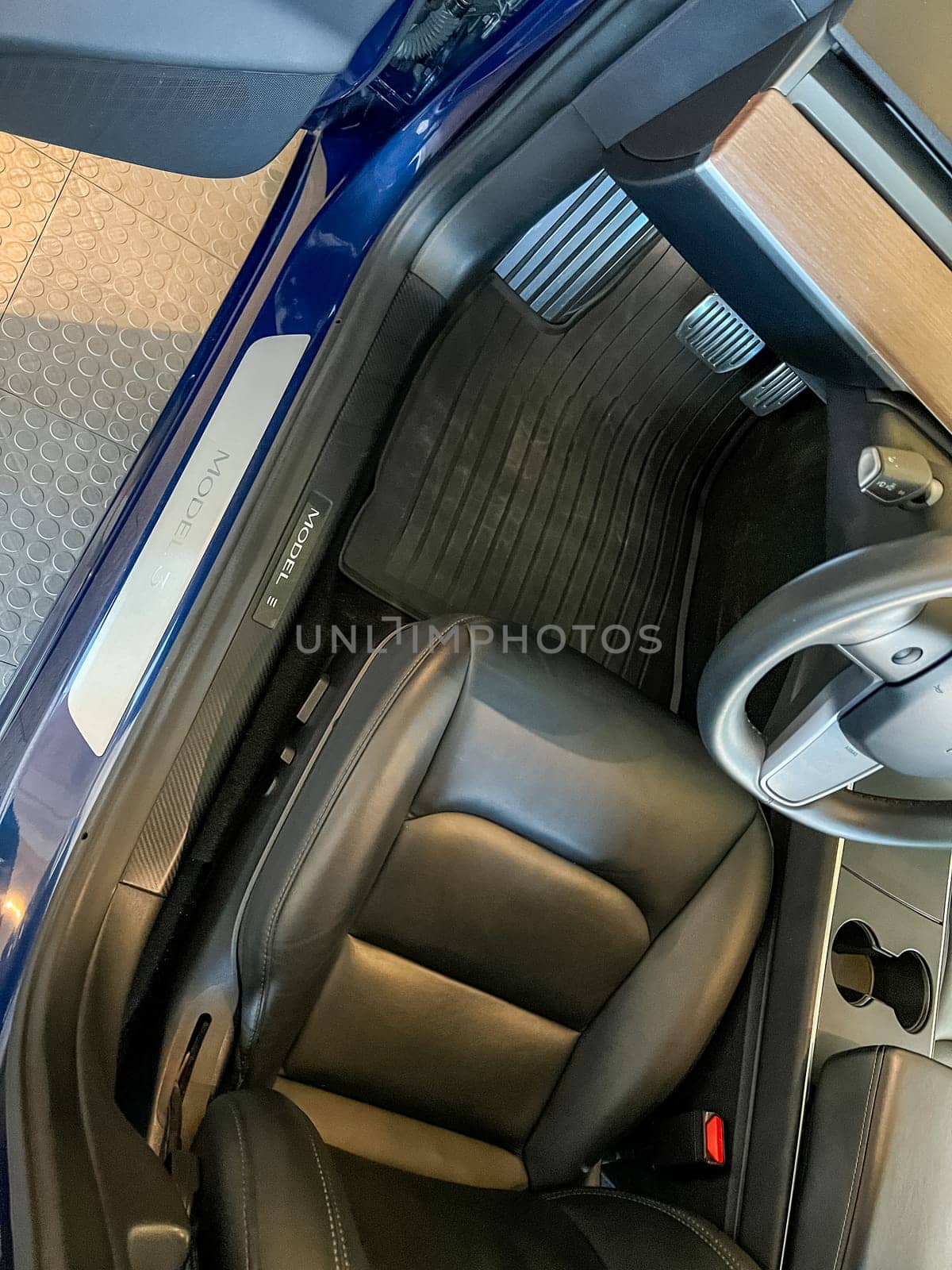 Castle Rock, Colorado, USA-March 14, 2024-The interior of a Tesla Model 3, featuring its premium black seats and modern dashboard, receives a meticulous cleaning in the garage of a private residence.