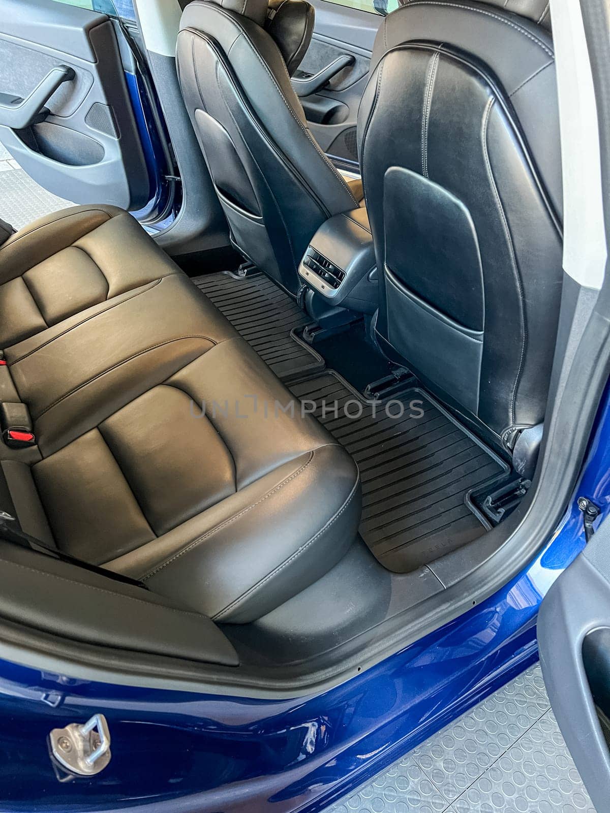 Castle Rock, Colorado, USA-March 14, 2024-The interior of a Tesla Model 3, featuring its premium black seats and modern dashboard, receives a meticulous cleaning in the garage of a private residence.