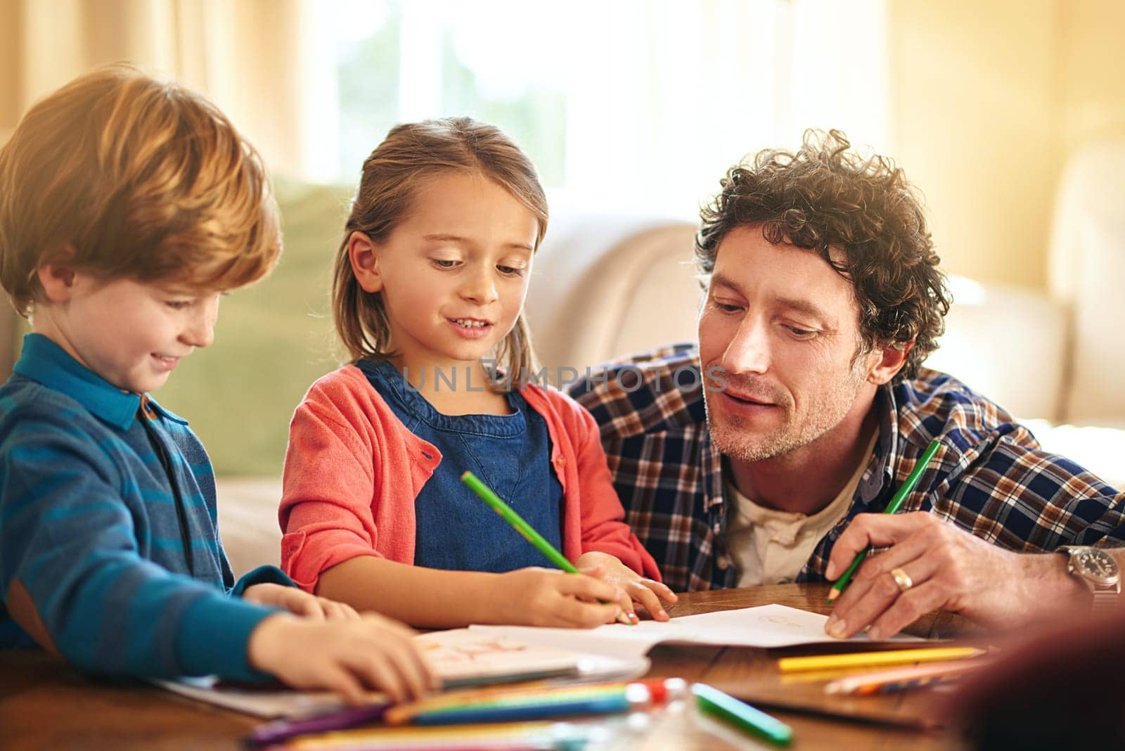 Father, kids and colour pencils for parenthood, fun learning and bonding on holiday or weekend. Dad, children and sibling with book stationery in lounge for drawing indoor activities with in home.