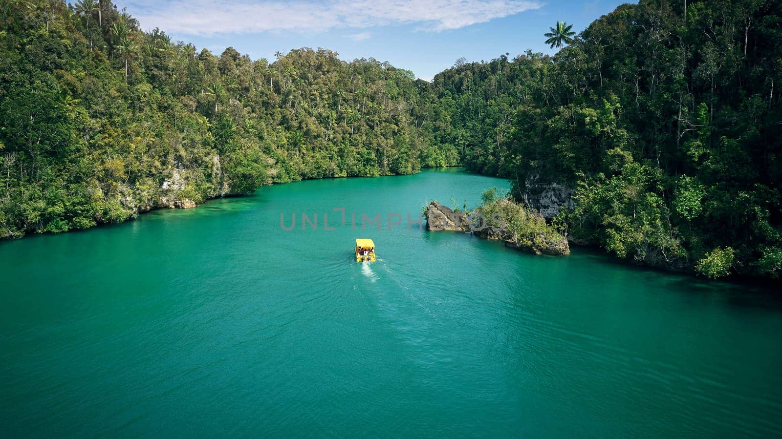 Adventure, tropical and island or lagoon by boat in Tahiti in outdoors with water, trees and jungle for landscape in summer. Vacation, transport and forest for explore, tourism and journey or nature by YuriArcurs