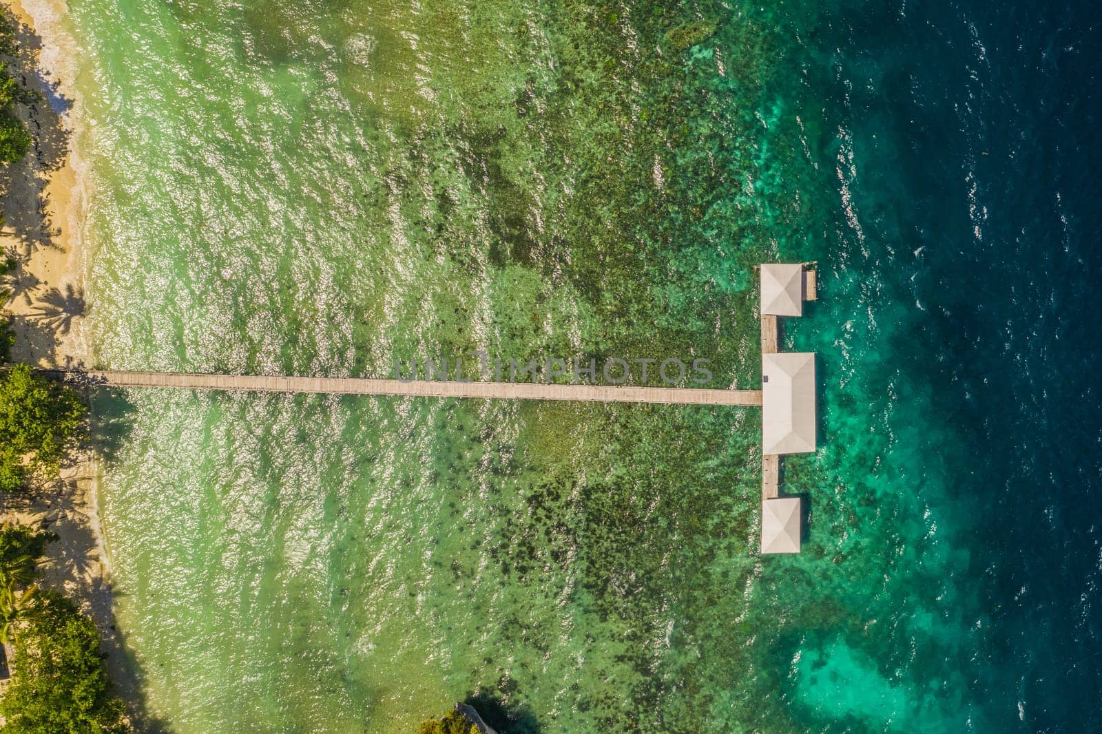 Nature, tropical and drone of sea, water and resort in Maldives, travel and vacation for summer. Holiday, tourism and seascape of beach, high angle and vibrant for adventure, outdoor and paradise by YuriArcurs