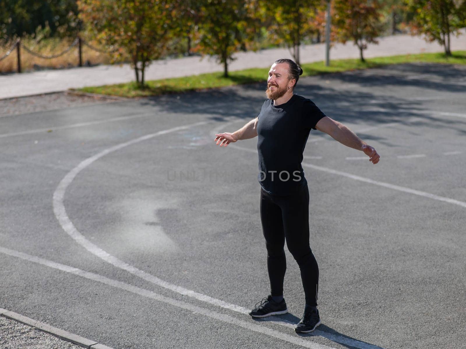 Bearded man doing exercises outdoors. by mrwed54