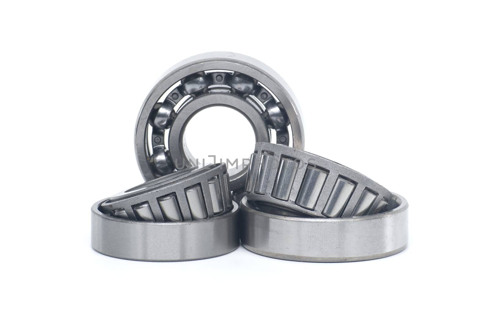 Single row tapered roller bearings and deep groove ball bearing without seal isolated on white background. Spare parts for machinery and automotive industry