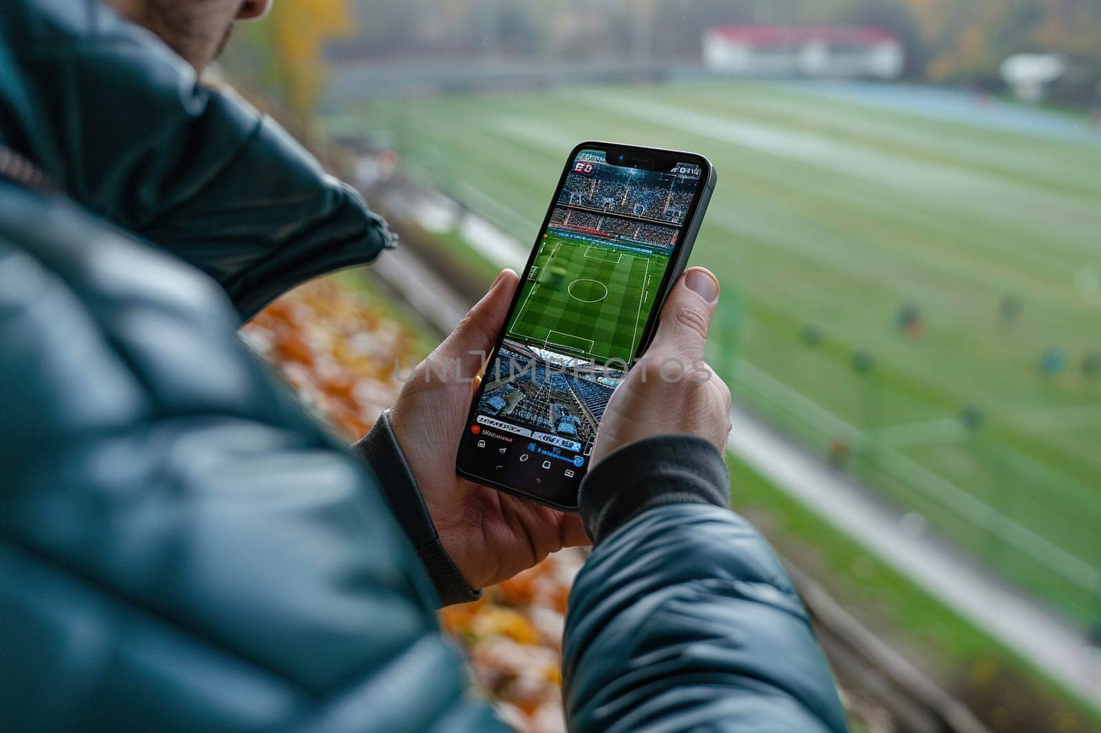 A man with a mobile phone in his hands watches an online football broadcast at the stadium. Concept of sports applications on mobile devices. Generated by artificial intelligence by Vovmar
