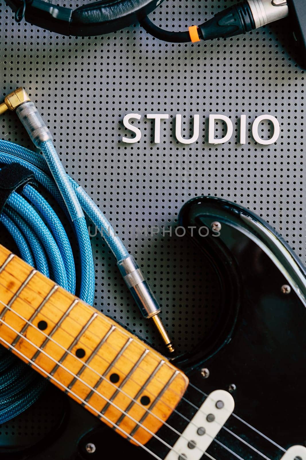 Electric guitar, Instuments and cables on a gray background. by ponsulak