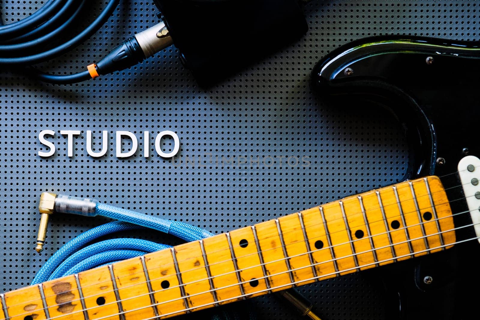 Electric guitar, Instuments and cables on a gray background. by ponsulak