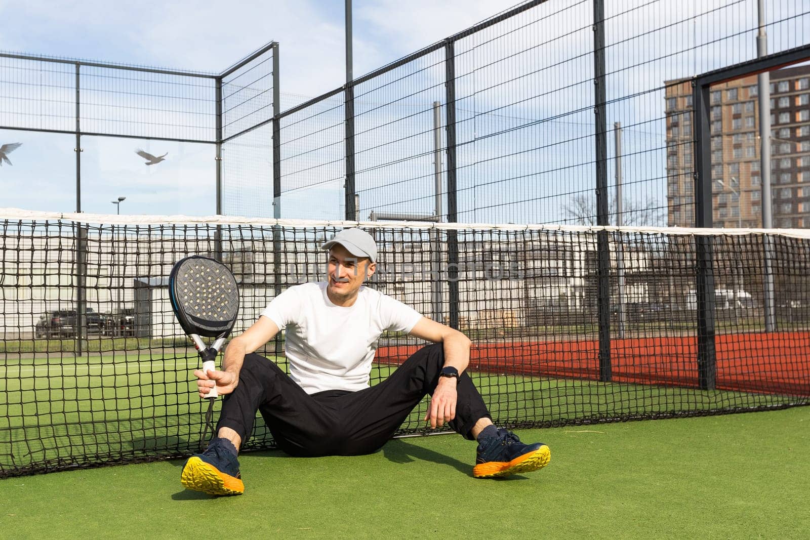 man playing paddle tennis court. High quality photo