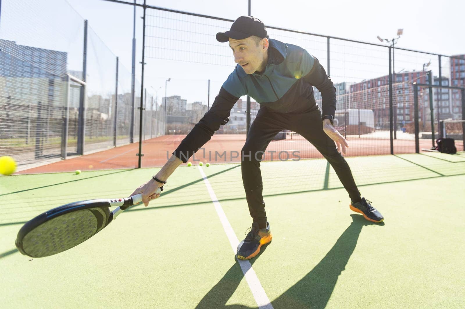 paddle tennis coach teaching on a residential paddle court, front view. High quality photo