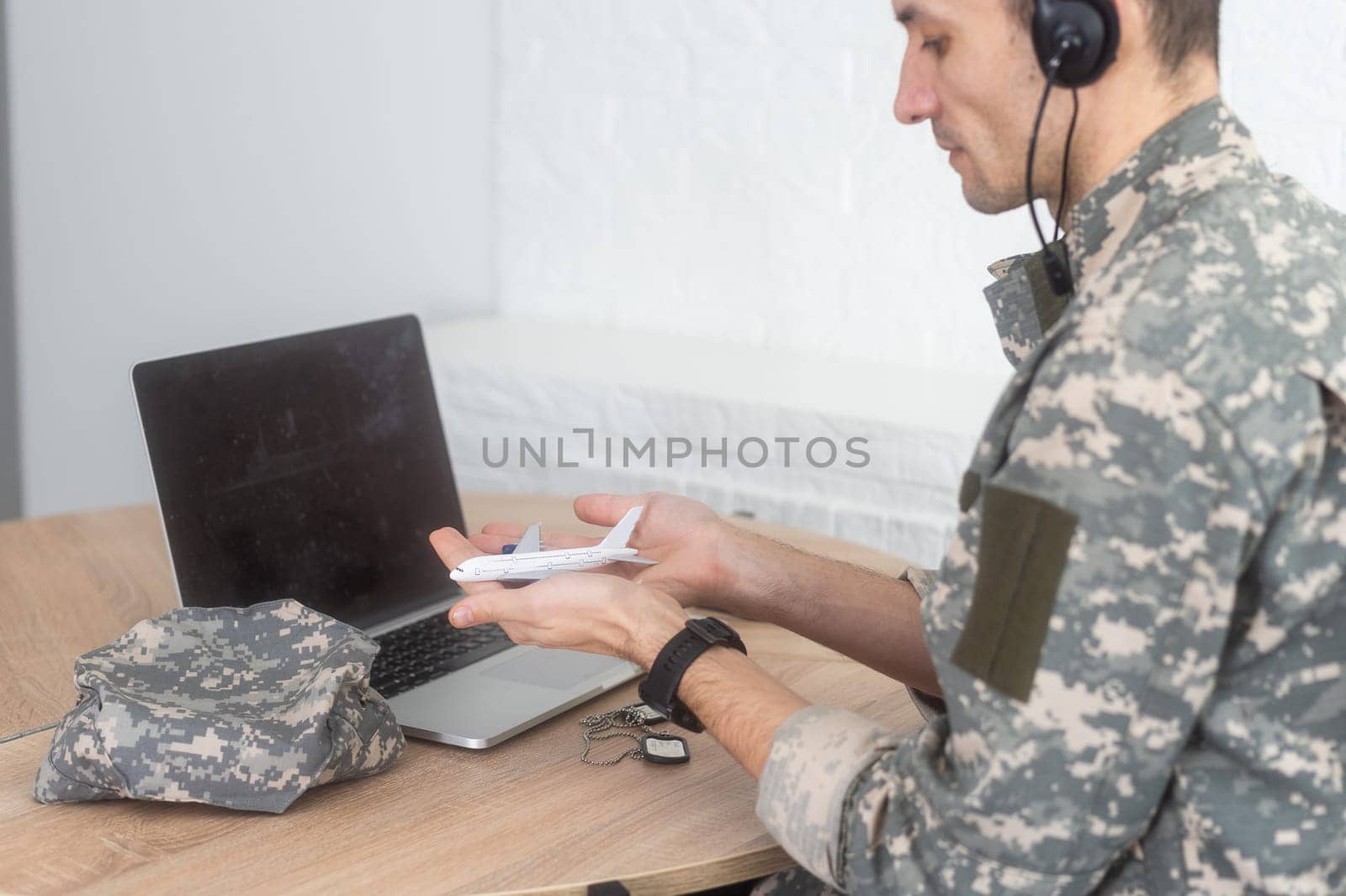 military man holding model plane. High quality photo