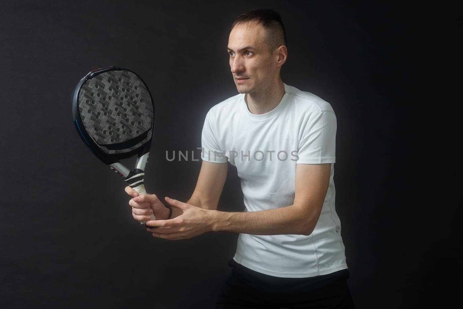 one caucasian mature man Paddle Padel tennis player shadow silhouette in studio isolated on black background. High quality photo