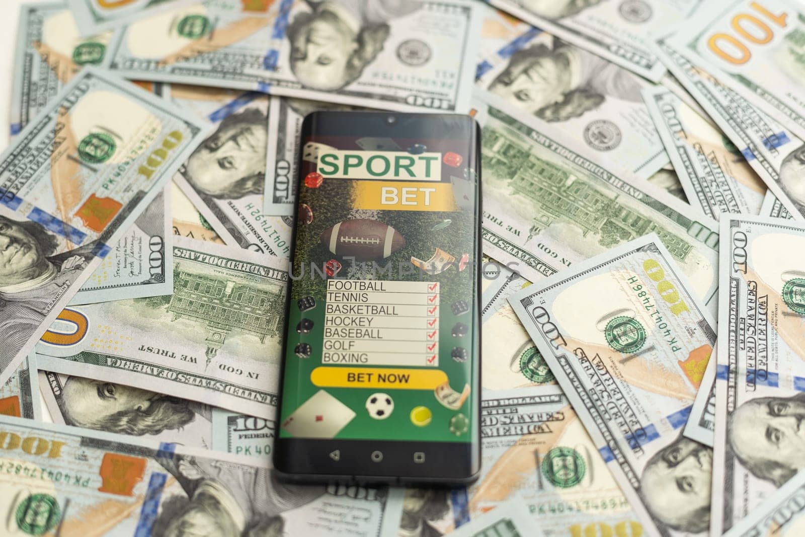 Sports betting website in a mobile phone screen, money. High quality photo