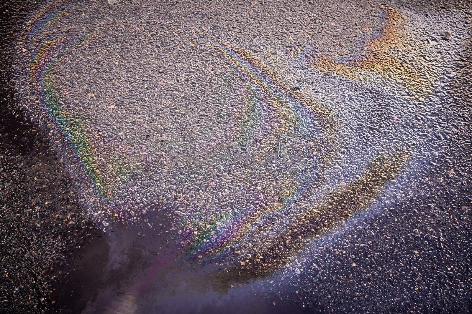 Oil stain on Asphalt, color Gasoline fuel spots on Asphalt Road as Texture or Background