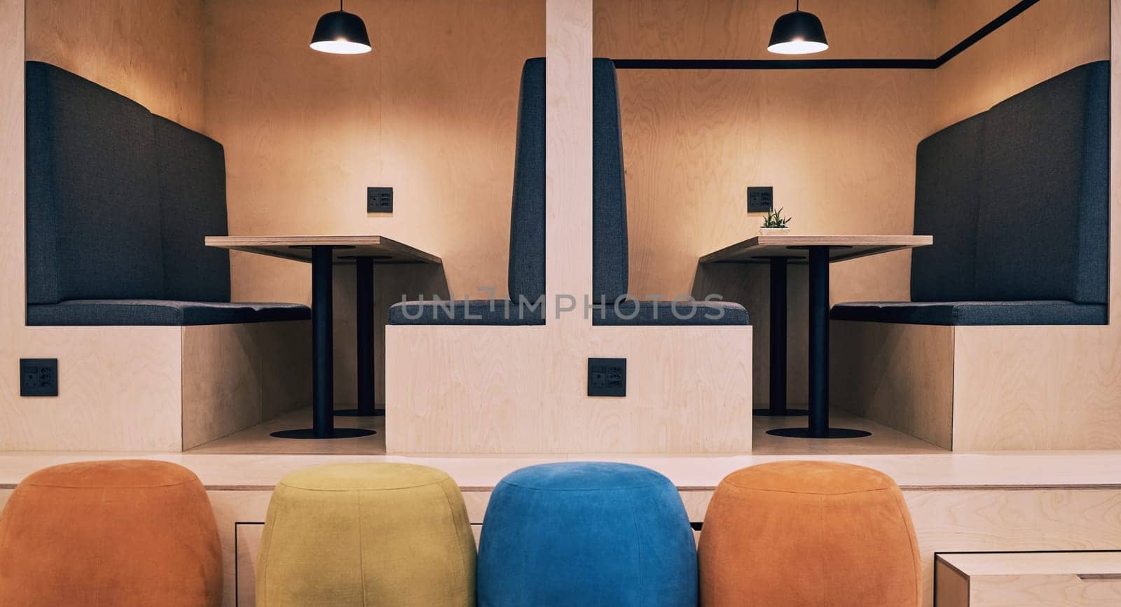 Interior, cubicle and startup empty office with furniture, background and chair at desk in coworking in workspace. Architecture, workplace and booth with art deco, design and room with vintage style by YuriArcurs