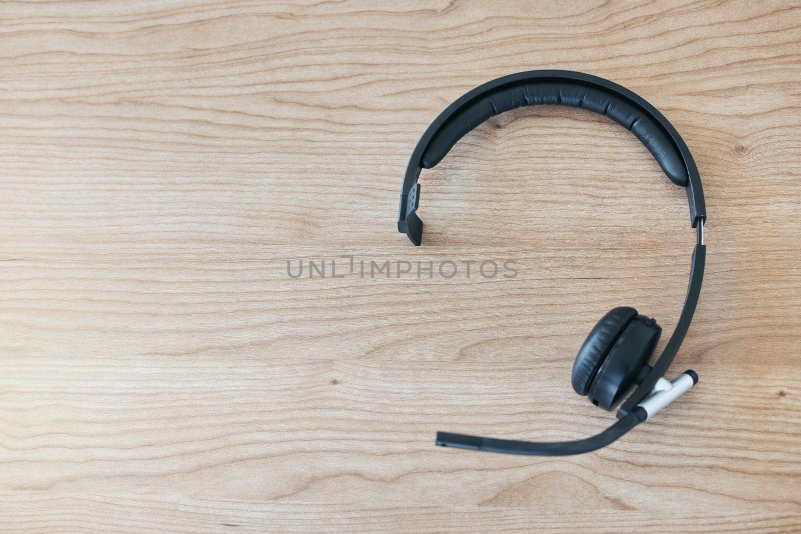 Wood background, headset and contact in call center for help desk, customer service or telemarketing. Tech support, table and headphones for communication, crm or tools for online consulting business.