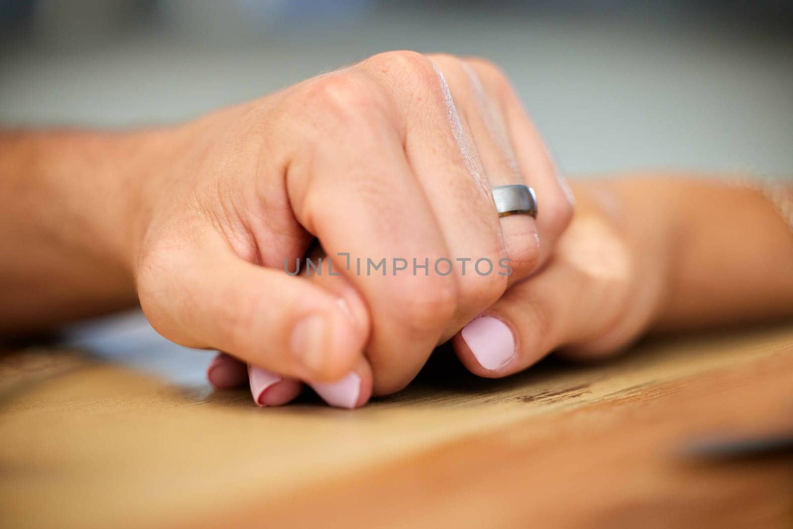 Holding hands, support and trust with couple, marriage and empathy together on table. Ring, care and love with unity in a relationship with help, compassion and romance with woman and man with grief by YuriArcurs