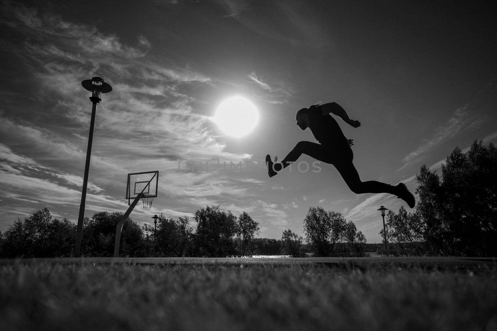 Caucasian man jumping with high hip raise outdoors