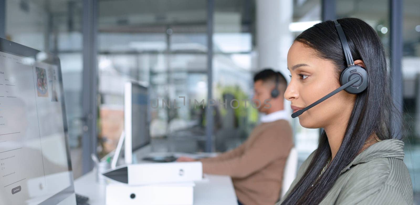 Call center, computer and woman with headphone typing for help desk, customer care or technical support. Headset, female consultant or telemarketer in office for crm, contact us and communication by YuriArcurs