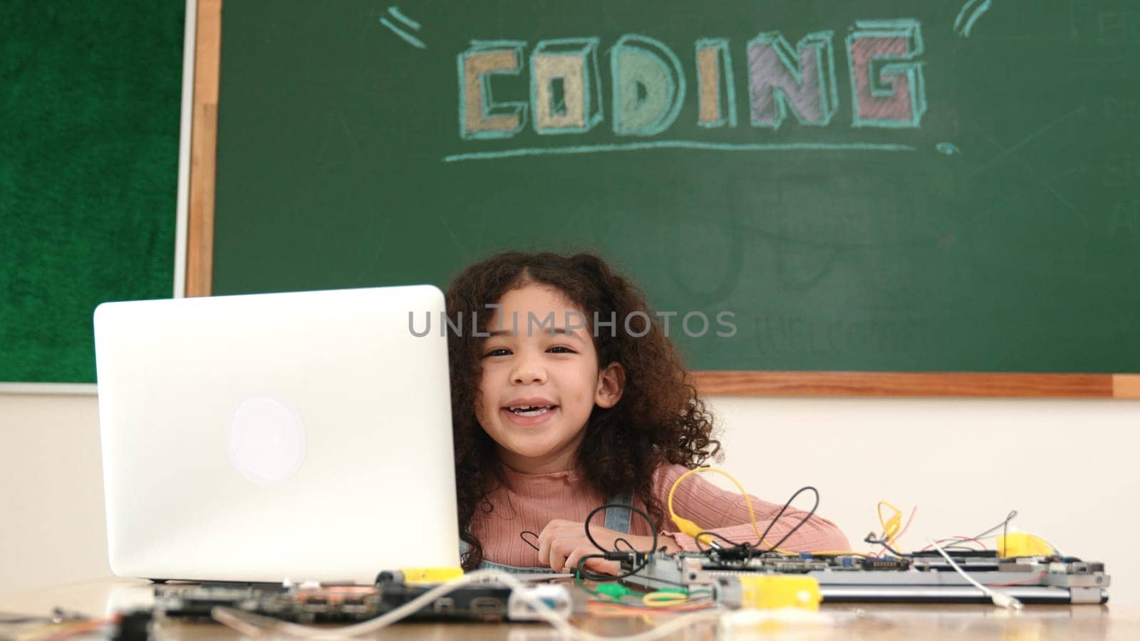 Attractive african student programing system while looking at camera. American girl working on her laptop while coding engineering prompt and generating AI by using software at Stem lesson. Pedagogy.