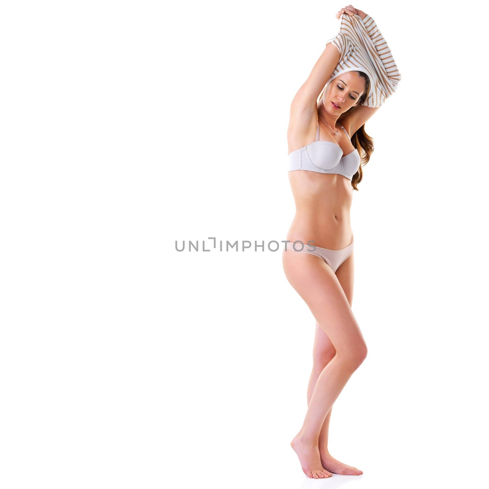 Woman, undress and studio with sweater or underwear for fashion on white background for confidence or conformable. Female person, lingerie and bikini or bra for desire, sexy and isolated with mockup by YuriArcurs