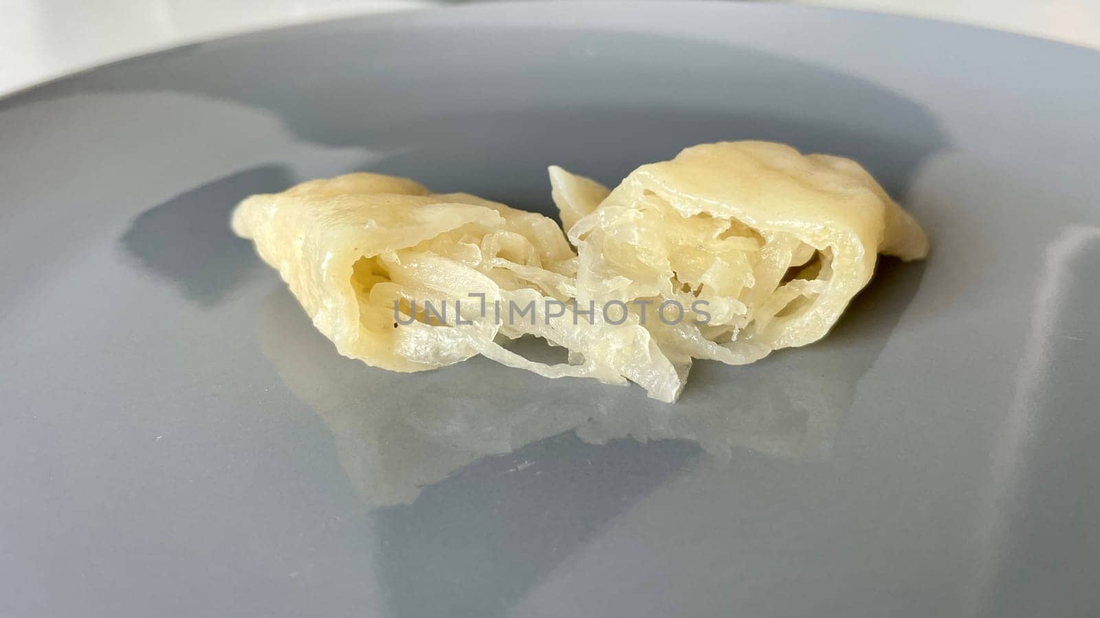 Dumplings with cabbage cut in half on a gray plate. High quality photo