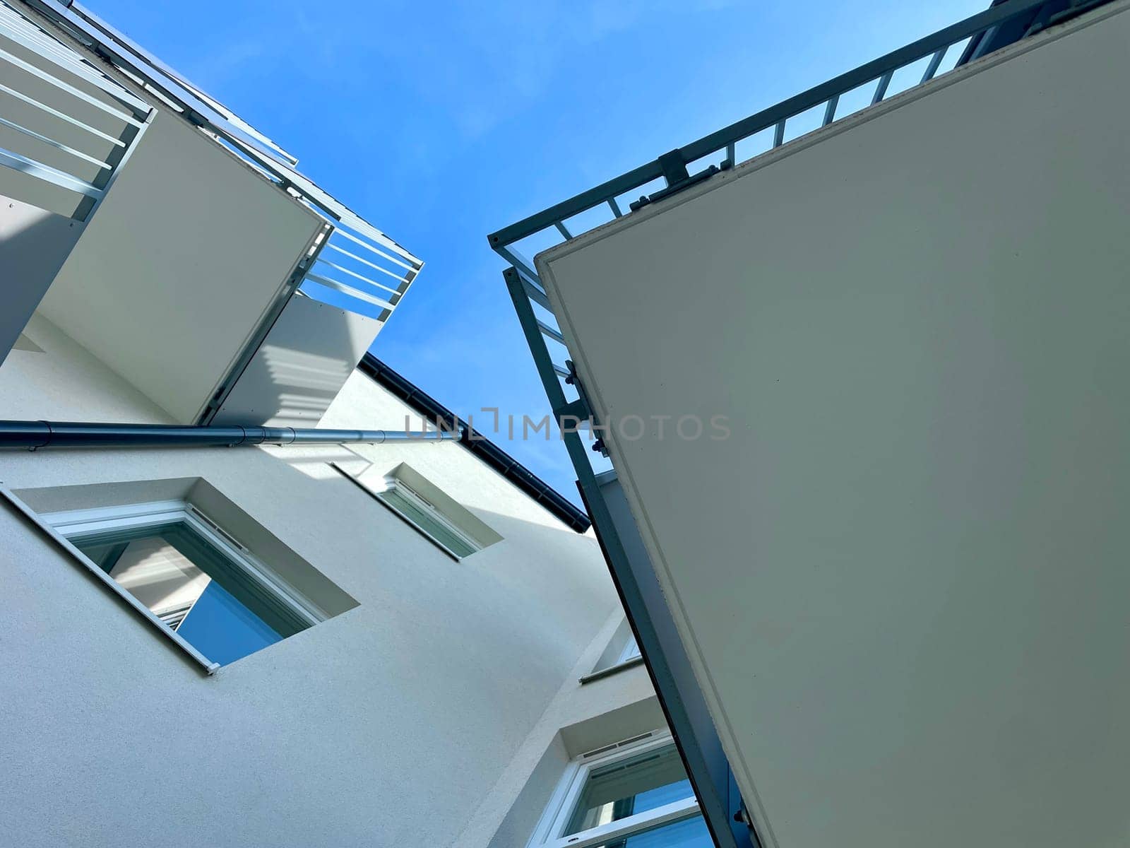 View of the sky between high-rise buildings, looking from the bottom up. High quality photo