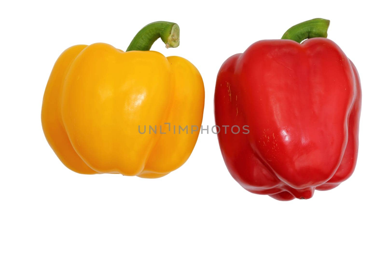 Yellow and red bell peppers on a white background, essential food ingredients.