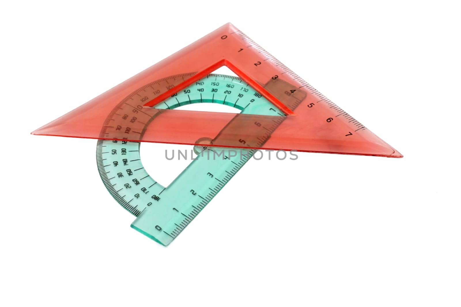 Plastic ruler and pencil on white background.