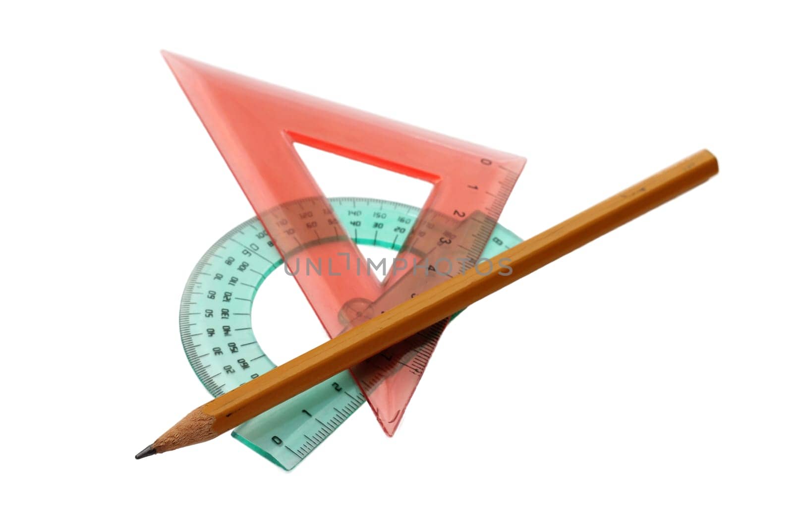 Plastic ruler and pencil on white background.