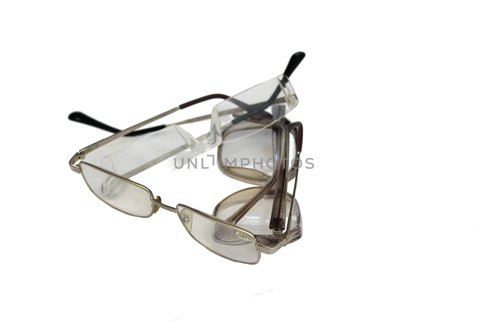 Three different glasses lie on top of each other isolated on white background.