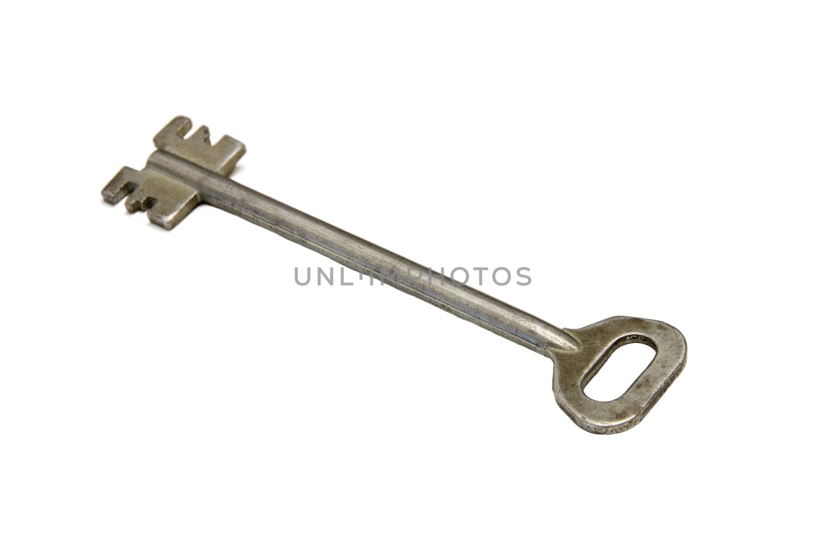 Closeup of a key, a tool made of nickel or steel, on a white background.