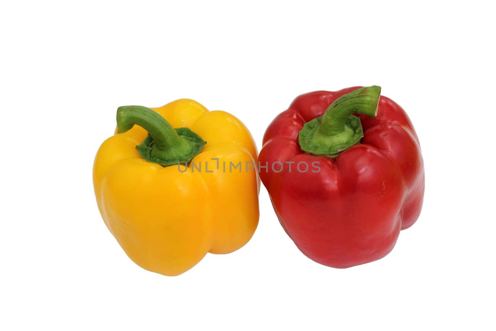 Yellow and red bell peppers on a white background, essential food ingredients.