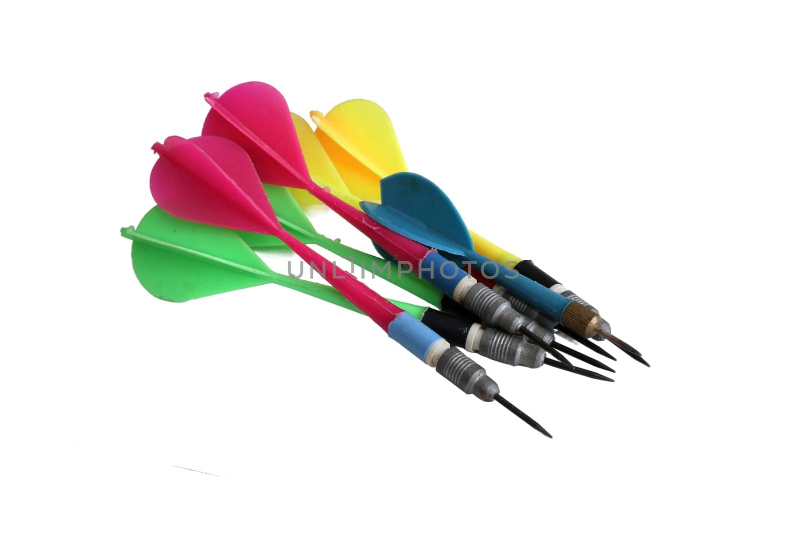 Colorful darts stuck with plastic feathers isolated on white background.