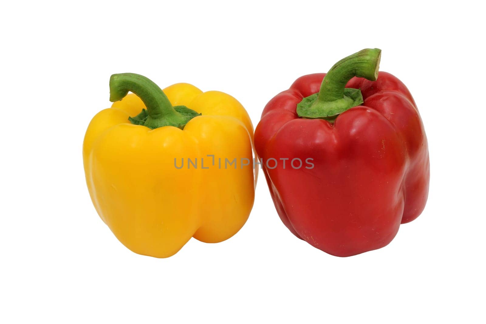 Yellow and red bell peppers on a white background, essential food ingredients.